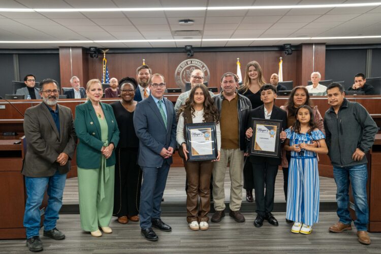 Taleen Kandakji & Yahir Ferreira stand with their families, city officials, and school leaders as they are formally recognized by the City of Aurora for being named Jack Kent Cooke Young Scholars.